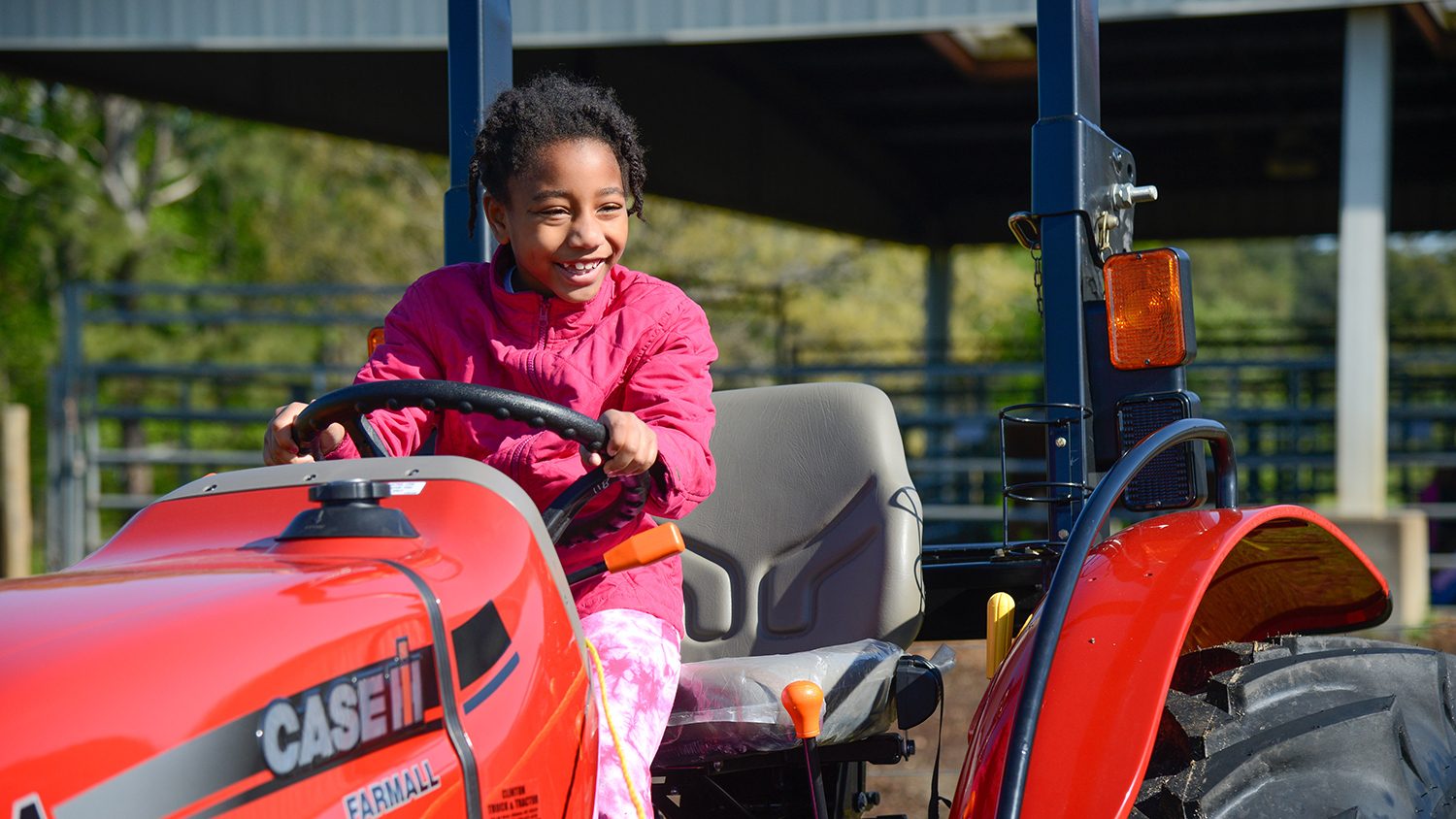 Little girl on tractor at CALS Farm Animal Days