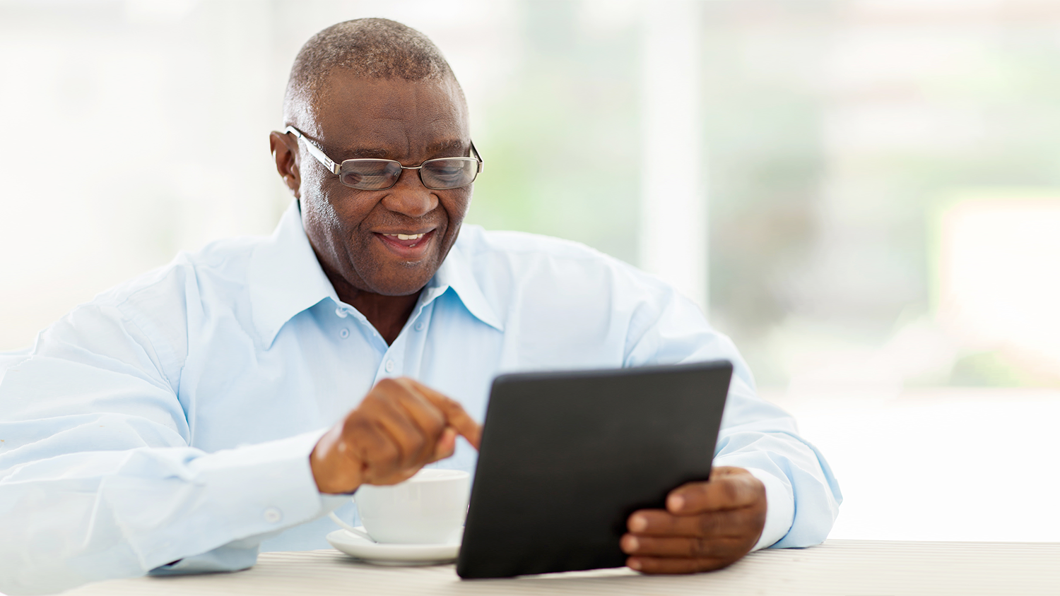Older African American man on tablet