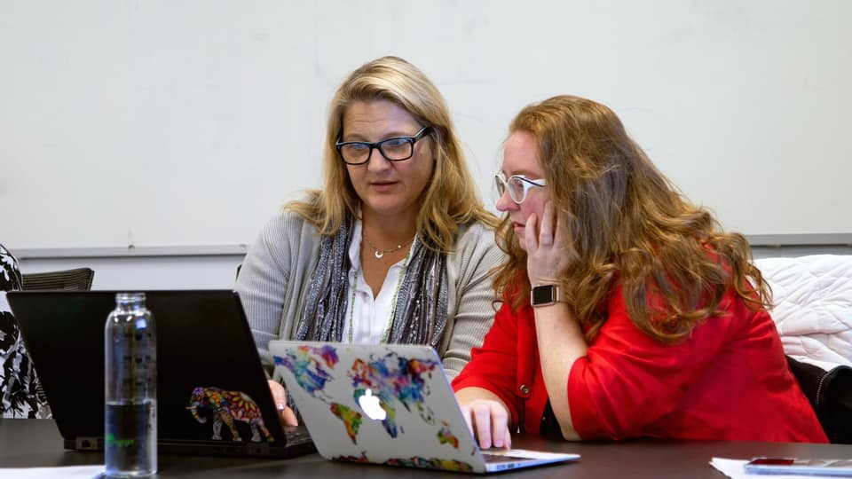 2 women looking at computer