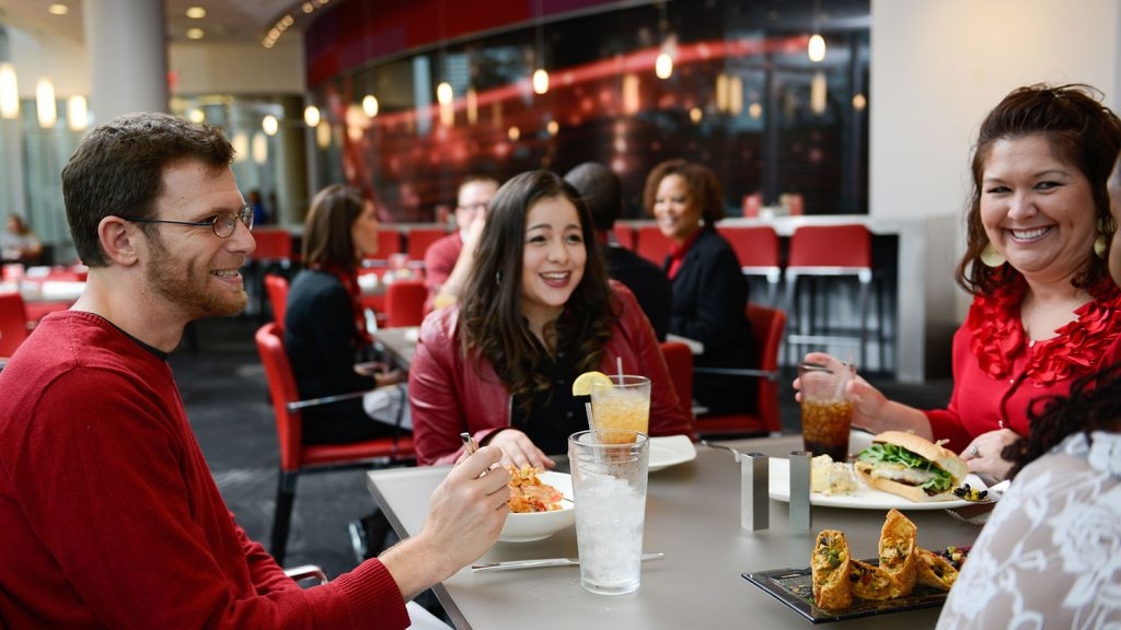 People sitting around a table and eating food