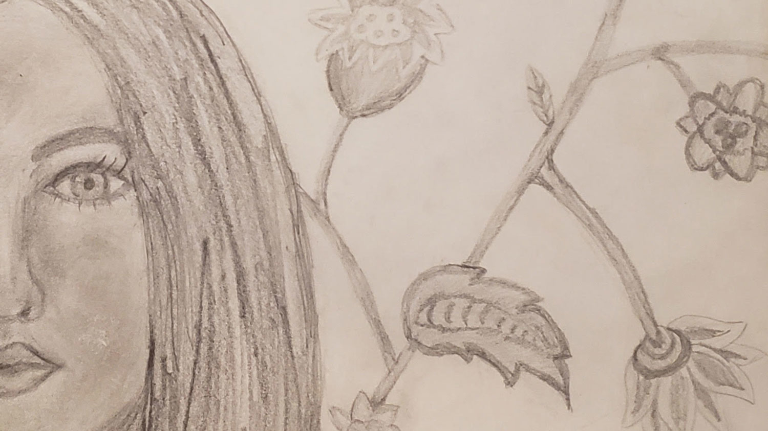 A drawing of a woman's face, leaves and flower buds.