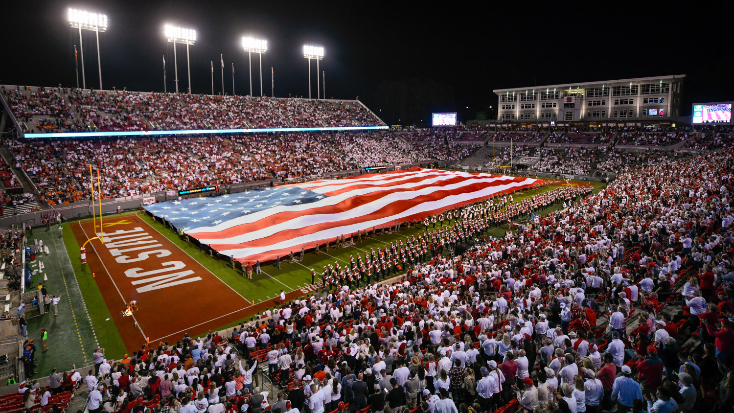 Large United States flag covers a football field