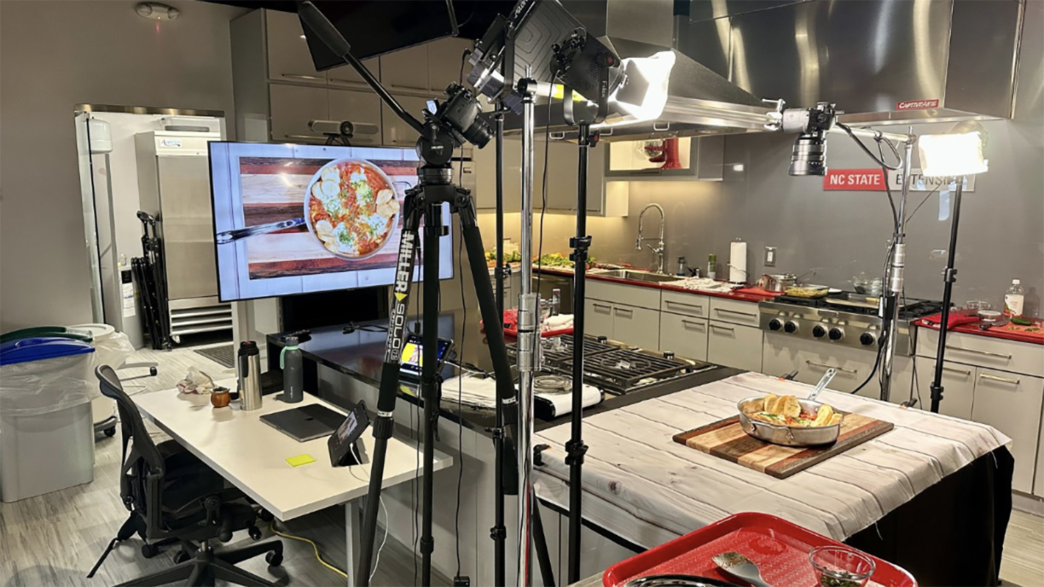 a test kitchen with lights and cameras to film a demonstration