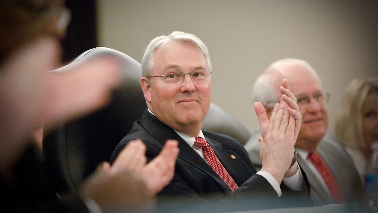 Chancellor Randy Woodson applauds a speaker at a Board of Trustees meeting in 2010