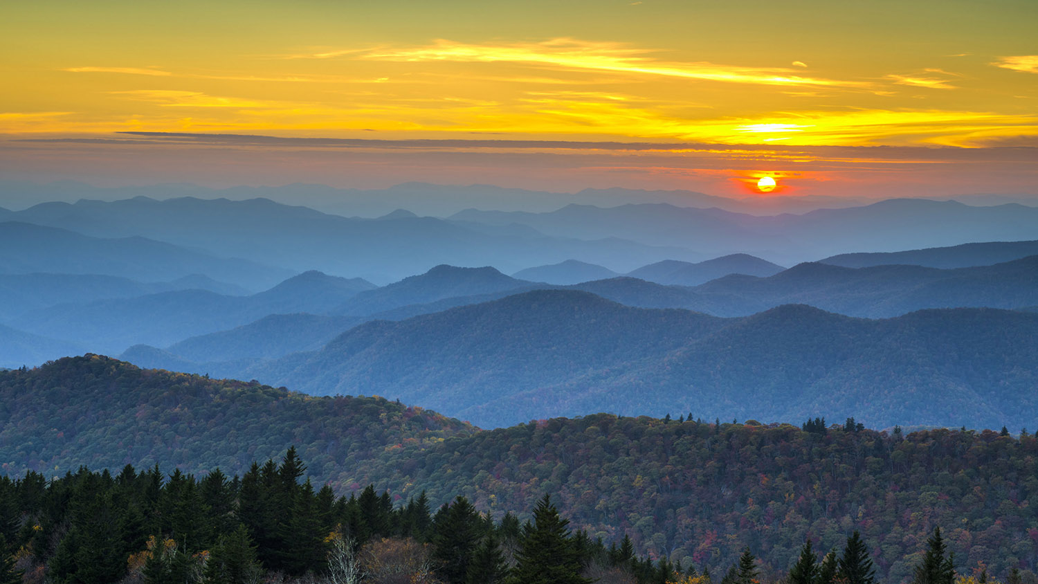 Blue Ridge Parkway Autumn Sunset over Appalachian Mountains Layers covered in fall foliage and blue haze