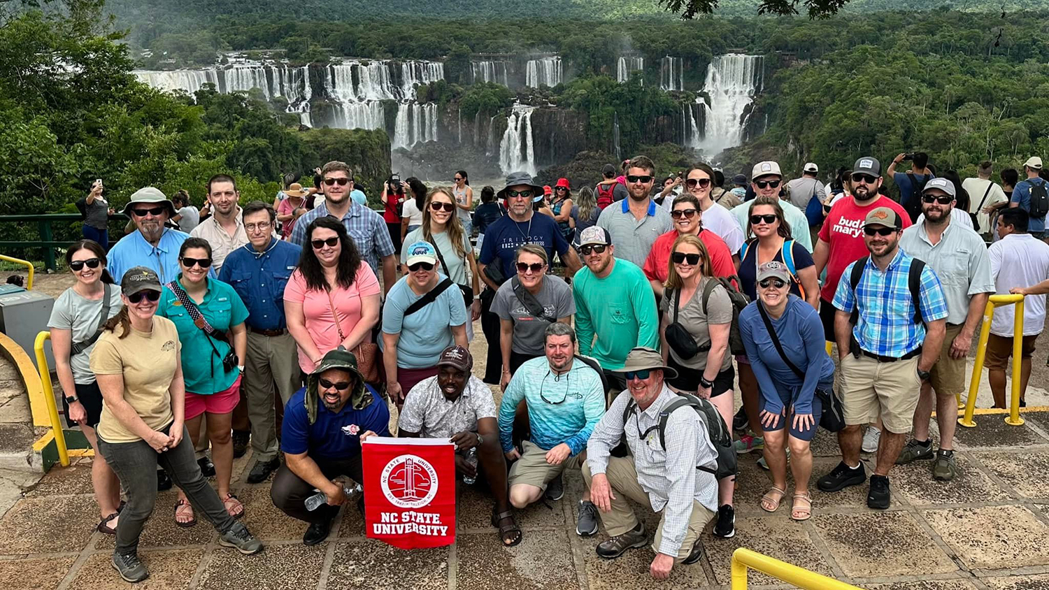 a group of people standing in front of waterfalls