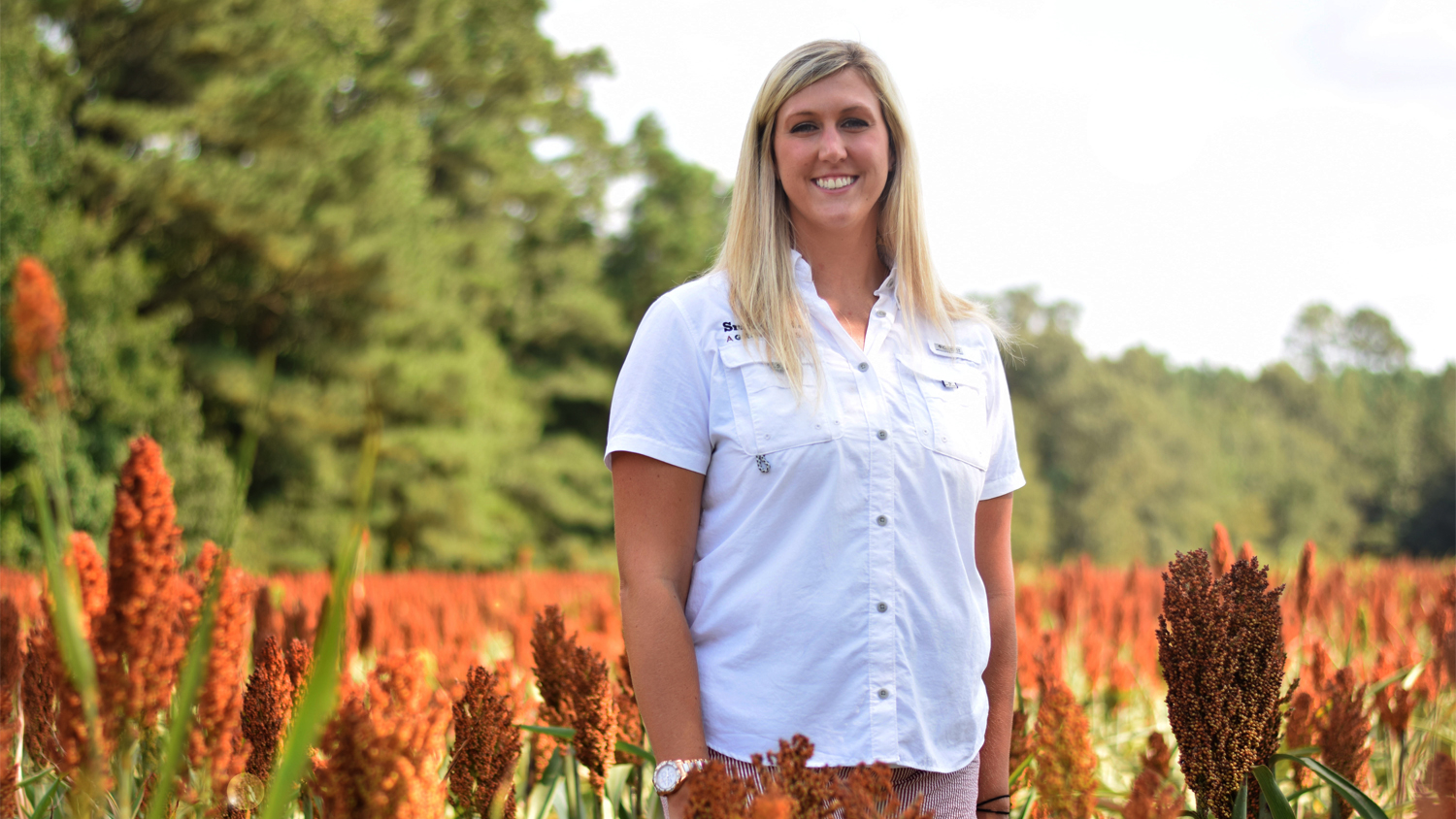 ABM alumna Rachel Grantham standing in a field.
