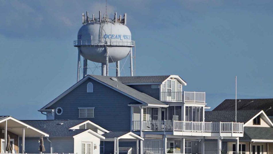 a water tower rising about homes on the coast of NC