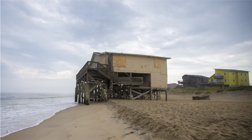 a home being encroached upon by rising sea levels