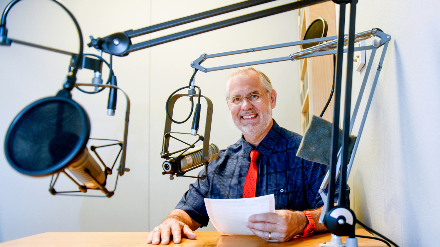 NC State College of Agriculture and Life Sciences professor Dr. Mike Walden working in a recording studio.