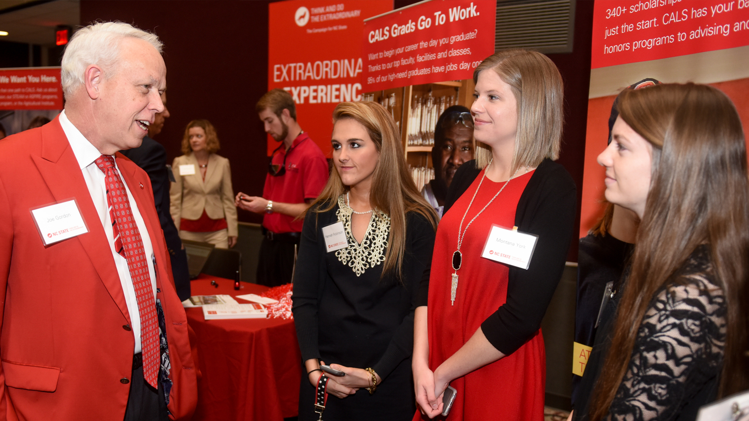 AGI students networking with NC State alums at event