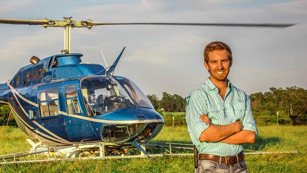 AGI graduate Jacob Tarlton in front of his helicopter.