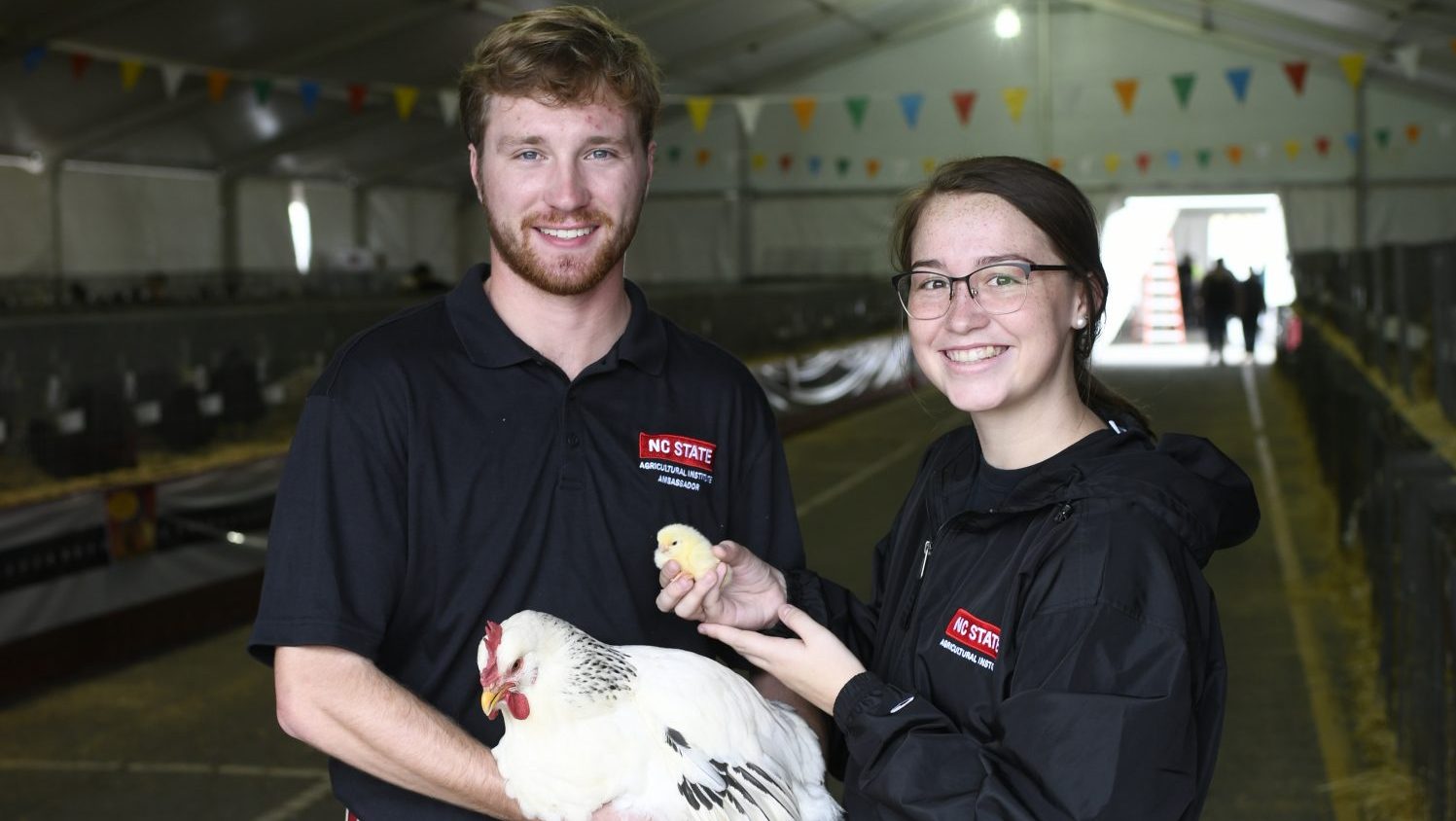 Students holding chickens.