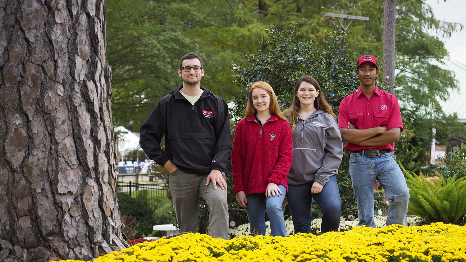 Four AGI students standing outside.