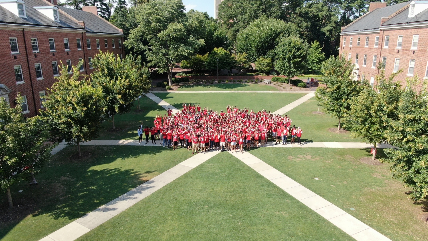 Housing staff pose for an aerial photo on campus