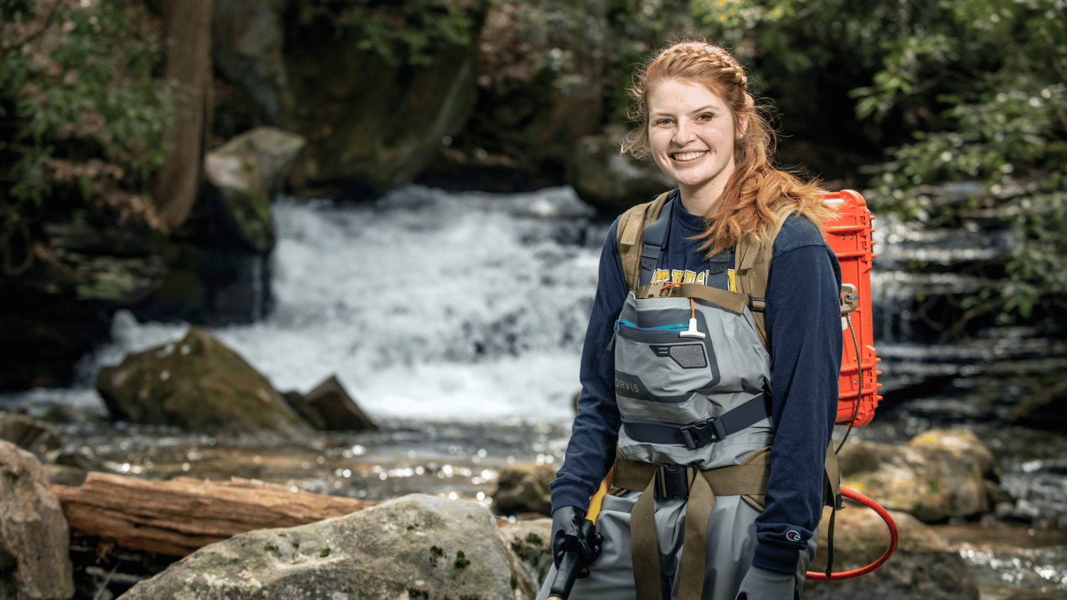 Bethany Wager in a stream conducting field work.
