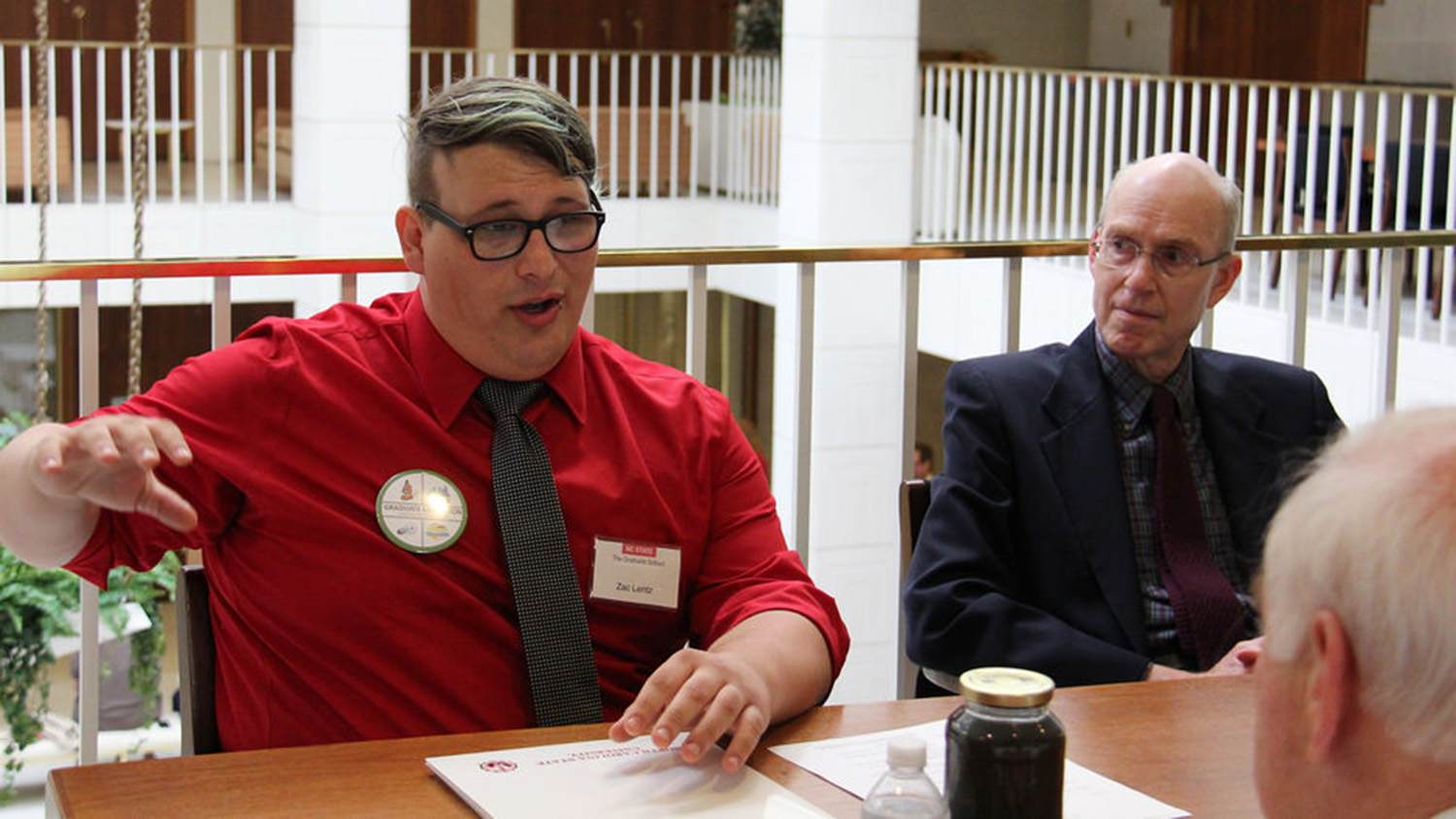 An enthusiastic Lentz gives Sen. John Alexander an overview of the potential of his research to solve one of North Carolina&#039;s difficult waste management problems.