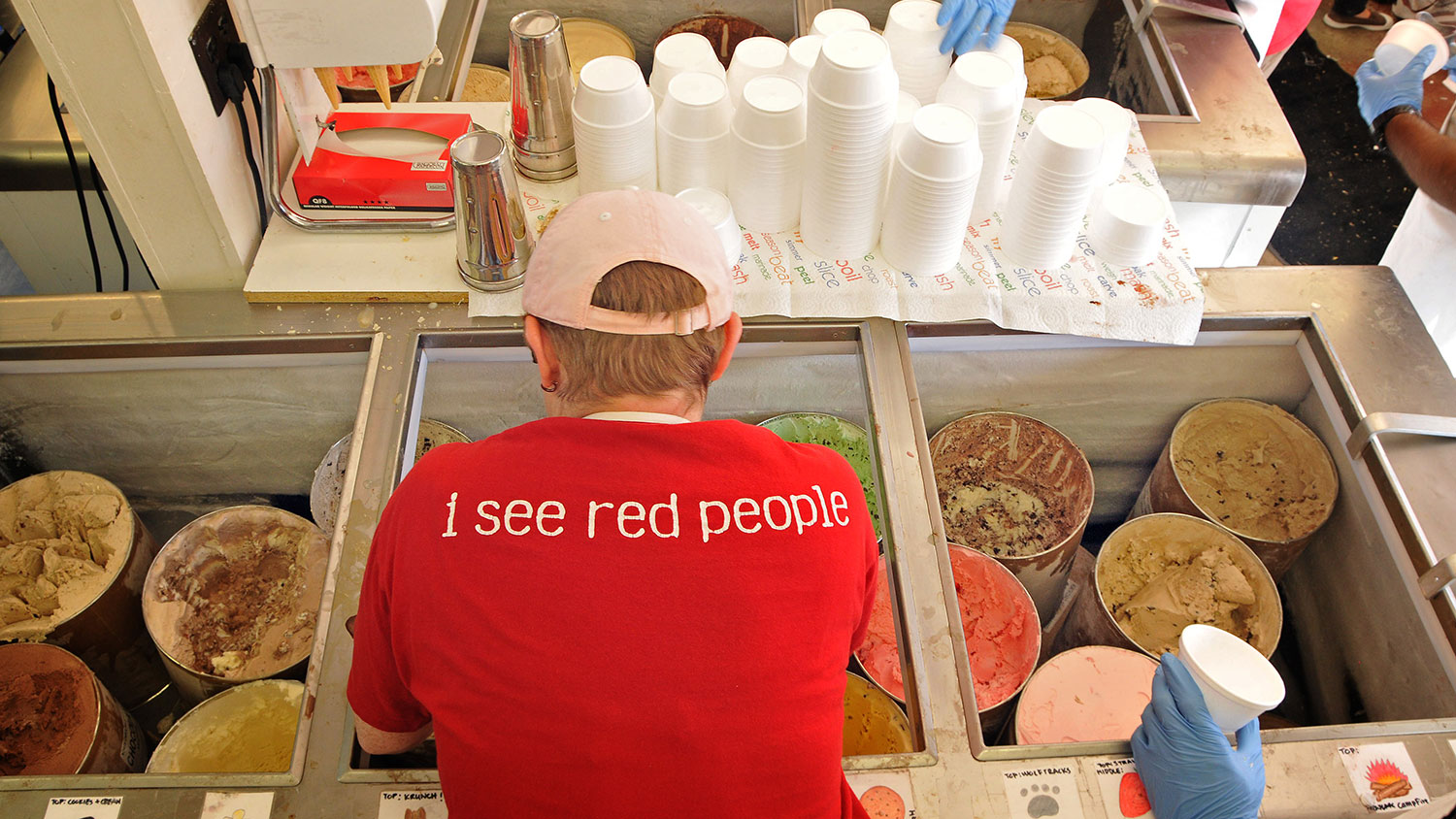 Worker scoops Howling Cow ice cream