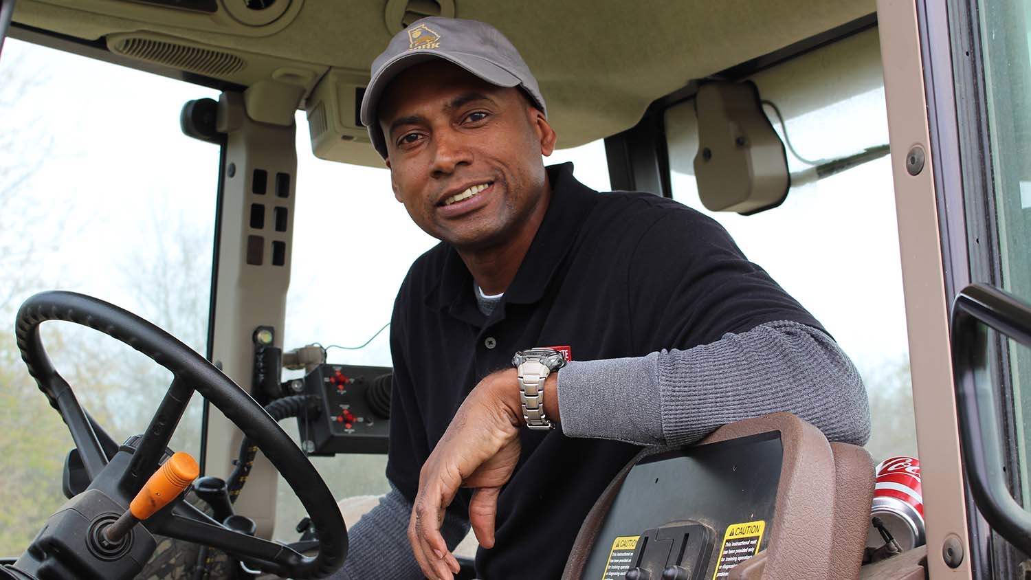 James Lamb in tractor cab.