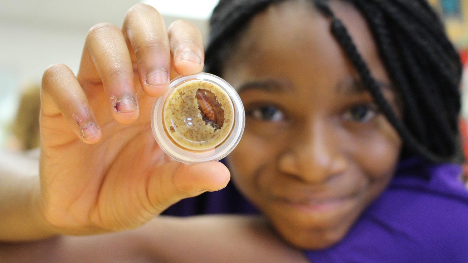 Student holding experiment sample