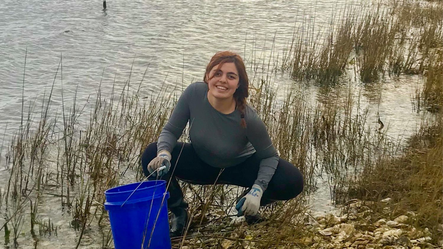 a female scientist with a bucket in water