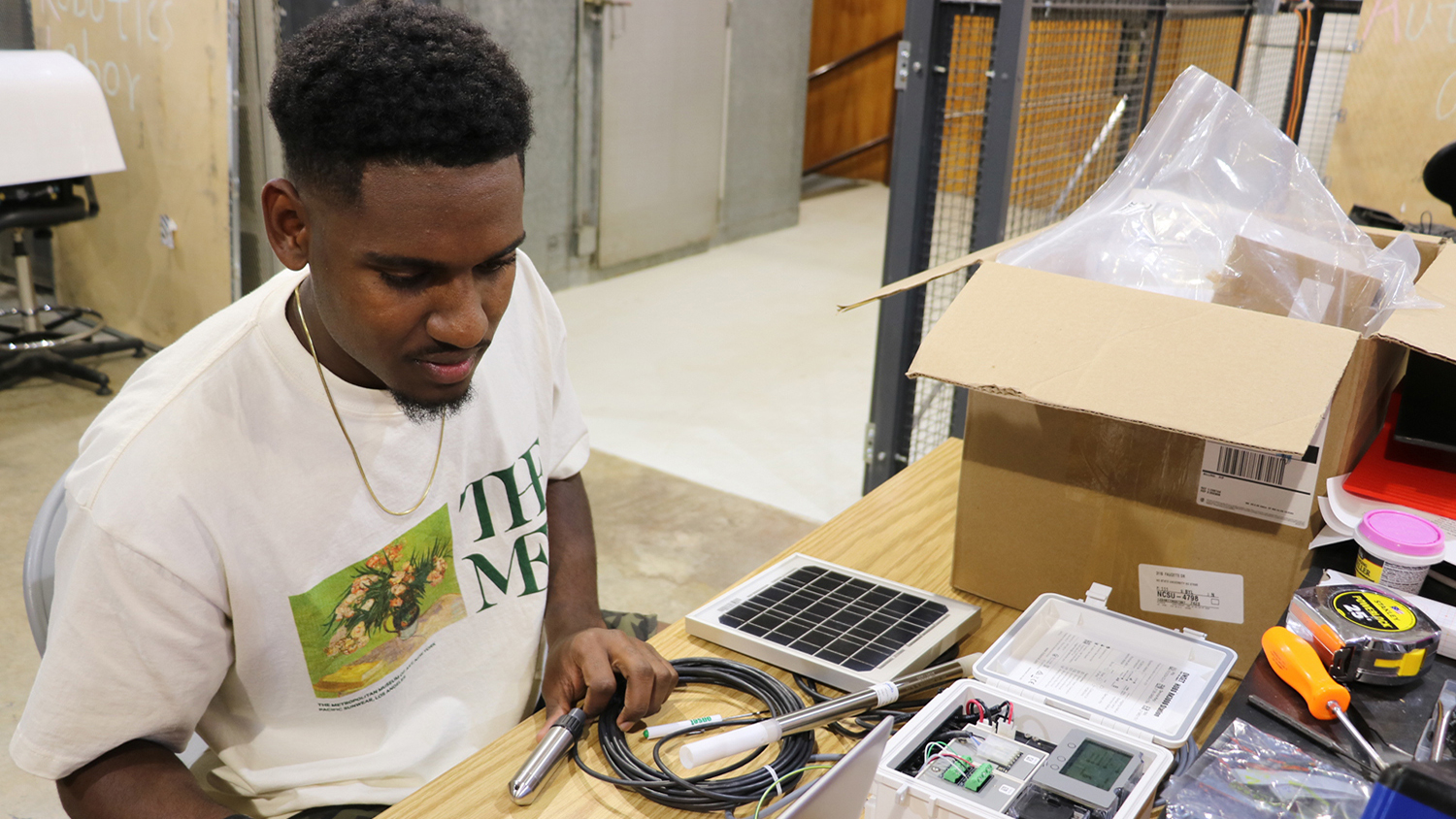 a young man sits at a computer