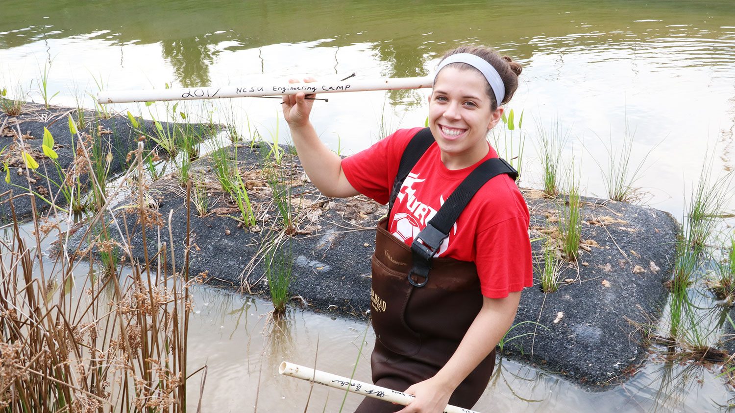 NC State student Dani Winter working in a pond