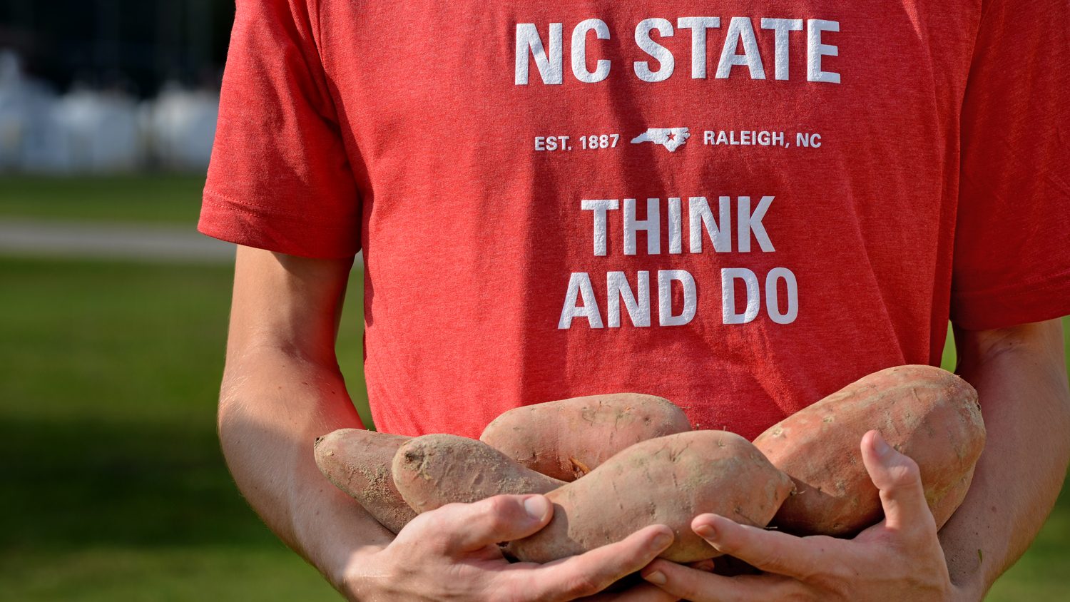 Closeup of student holding sweet potatoes