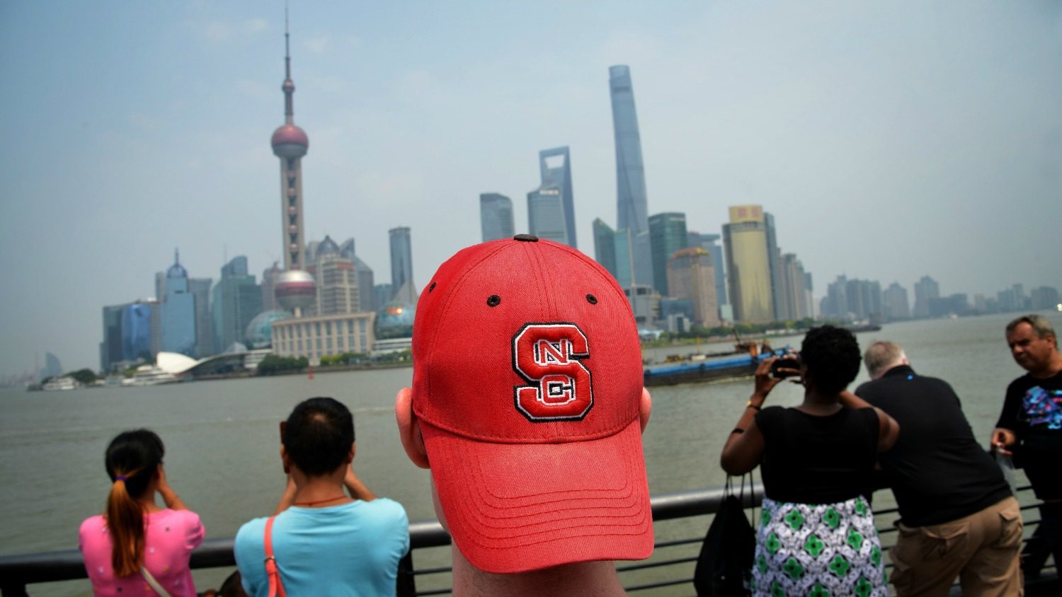 NC State’s Sean Lang sports his Wolfpack pride on his head while touring The Bund in Shanghai.