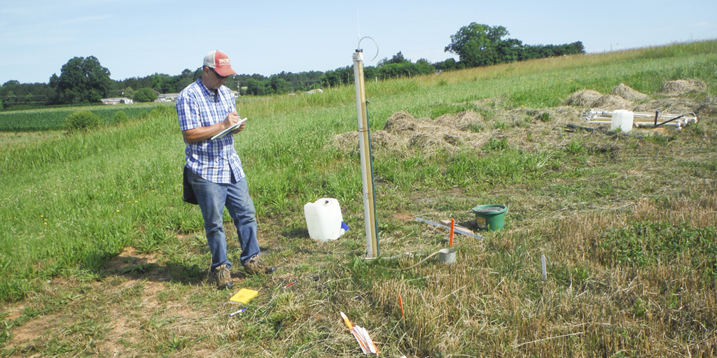 Man measures soil samples in the field