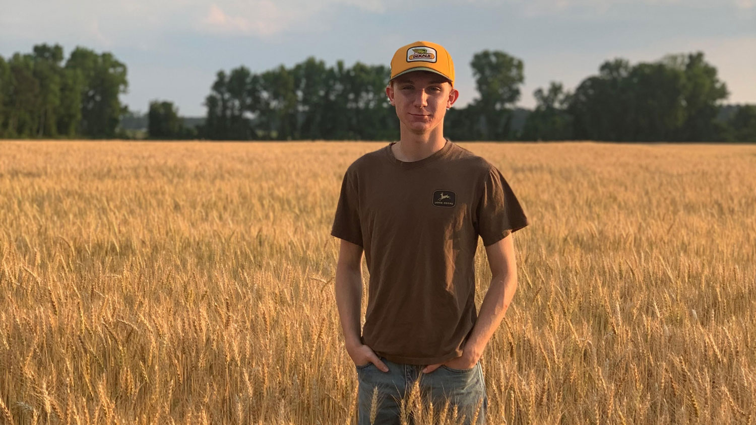 NC State student in a wheat field