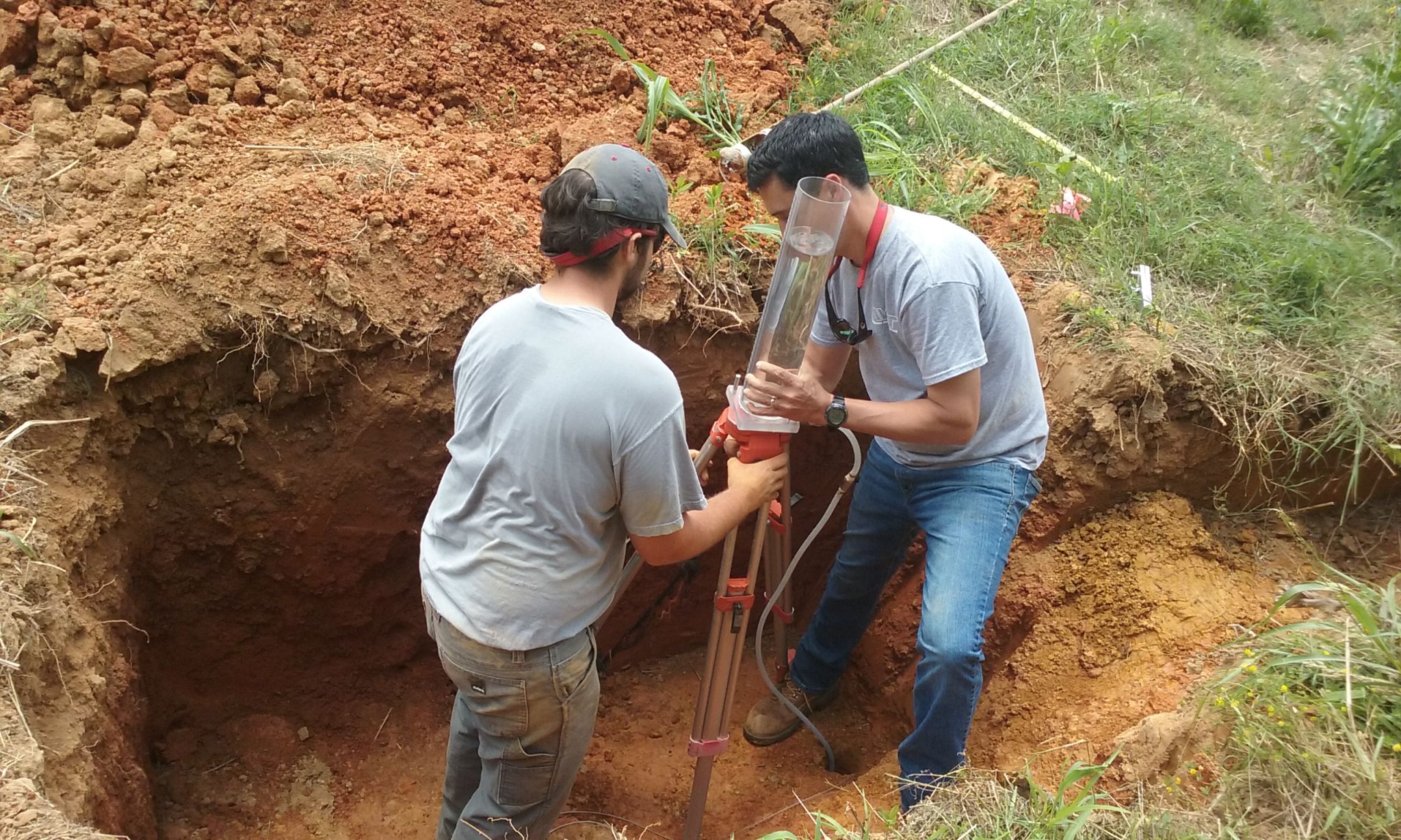 Two soil scientists take field samples