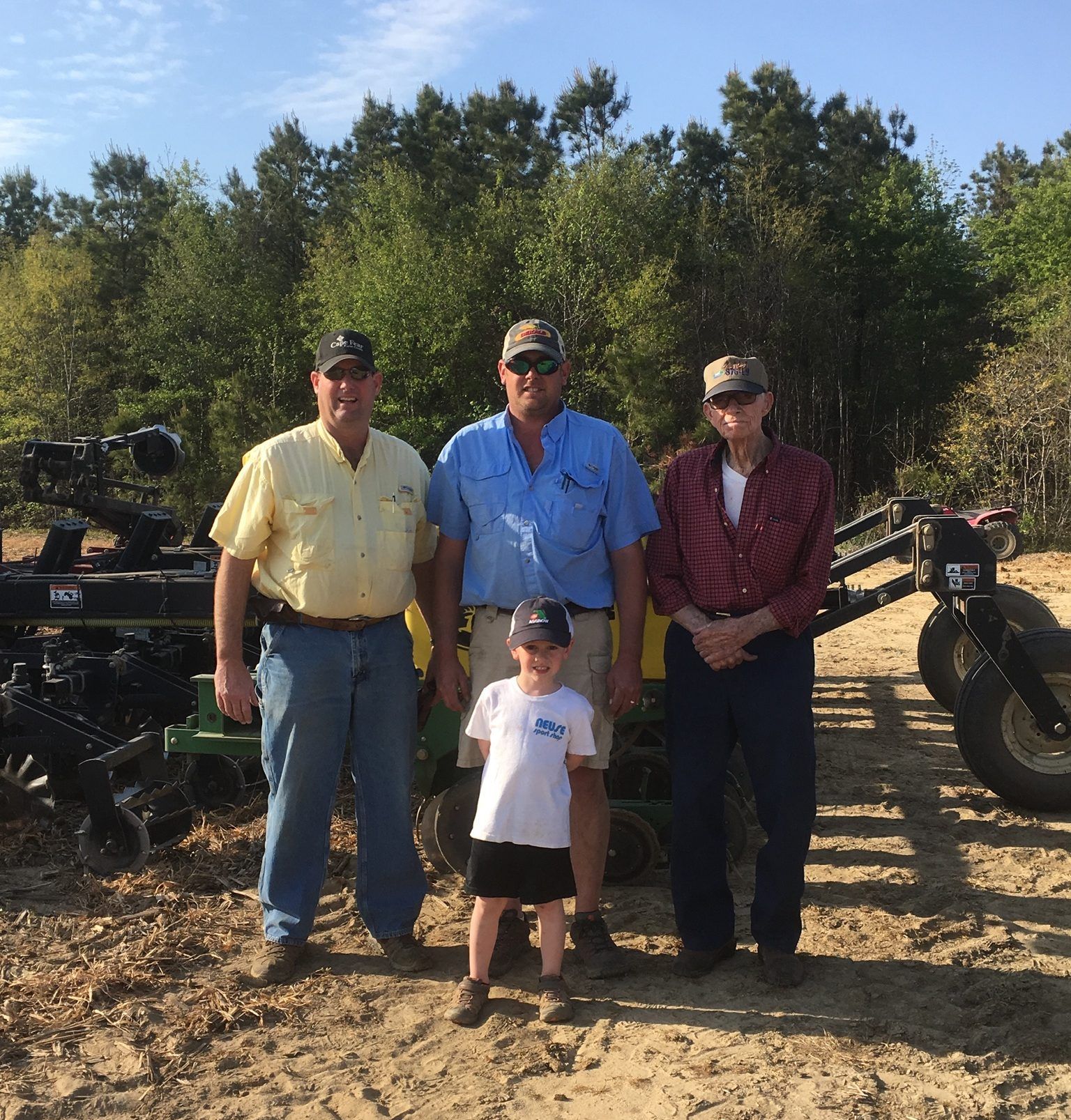 Four generations of farming men pose together