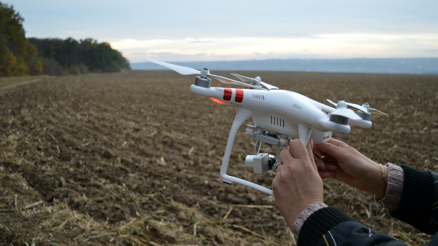 a student holds an agricultural drone