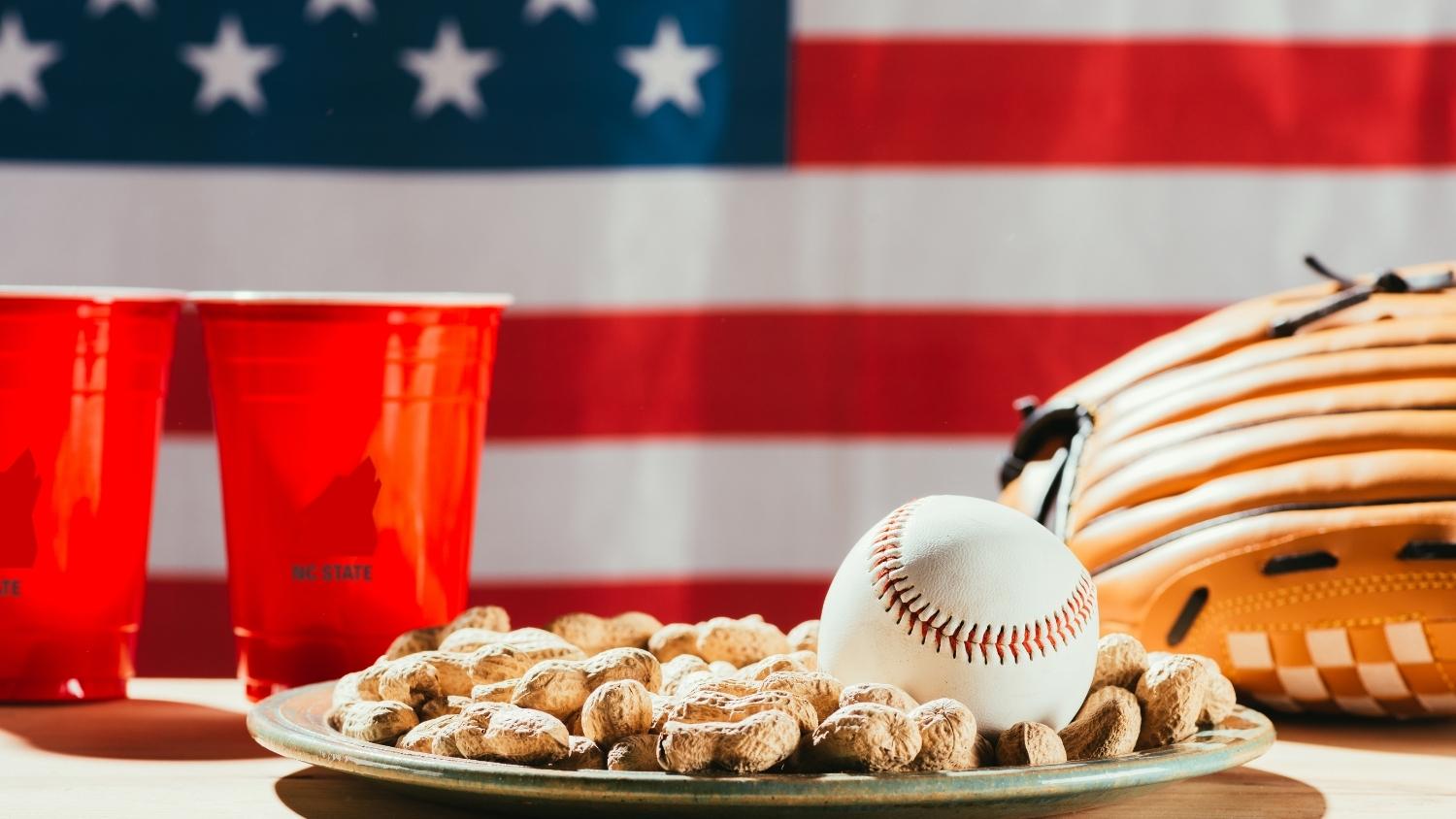 In-shell peanuts on a plate with a baseball
