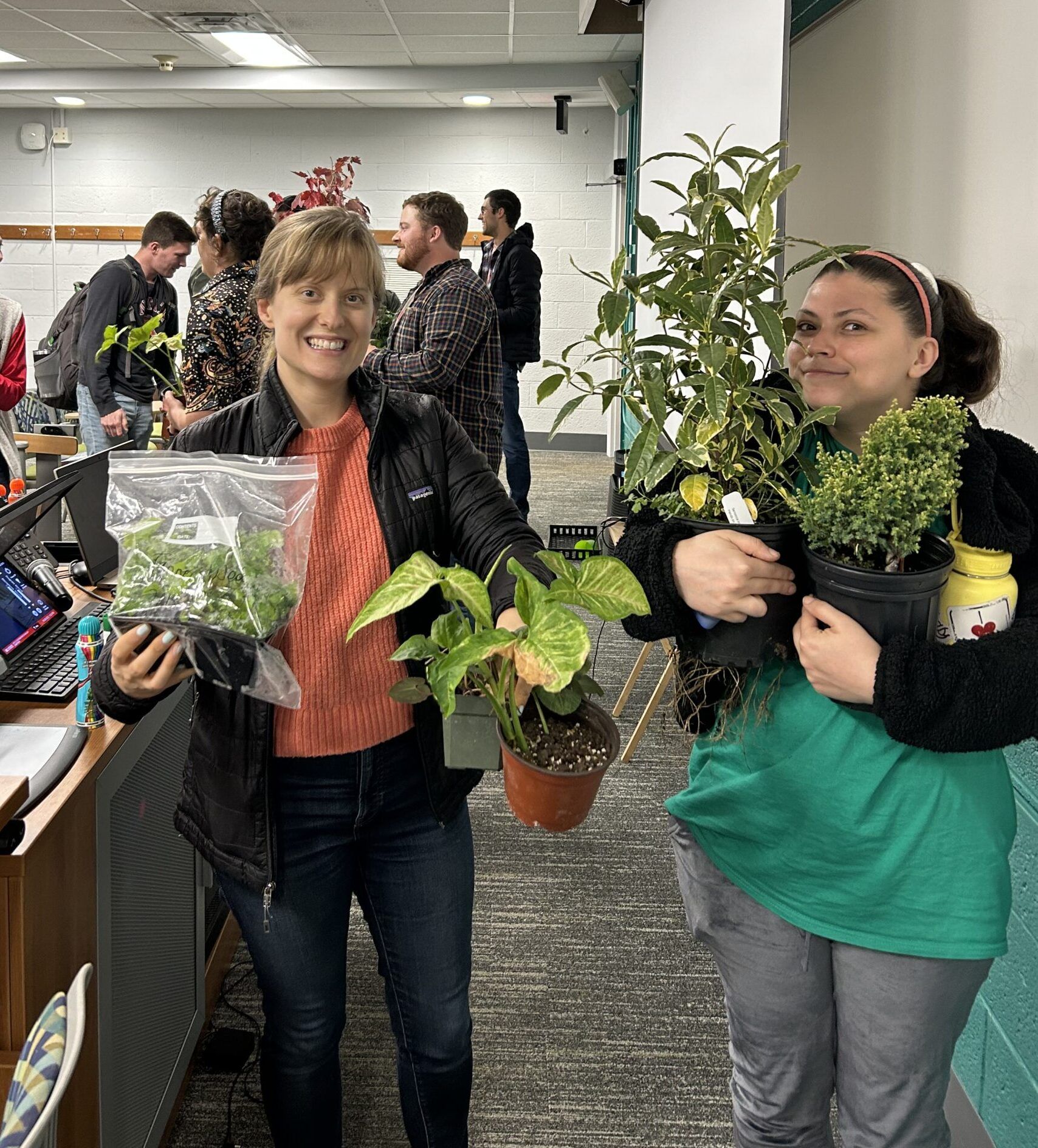 NC state crop and soil sciences graduate students pose with plant winnings from bingo
