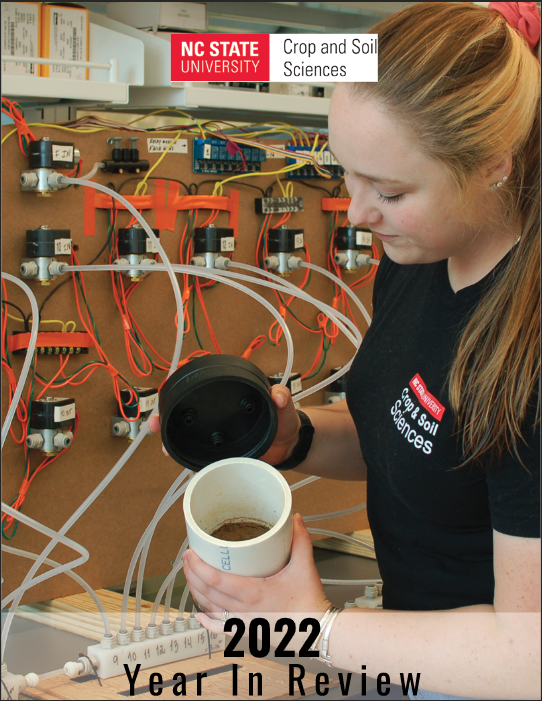 A soil science graduate student looks into a soil measurement chamber