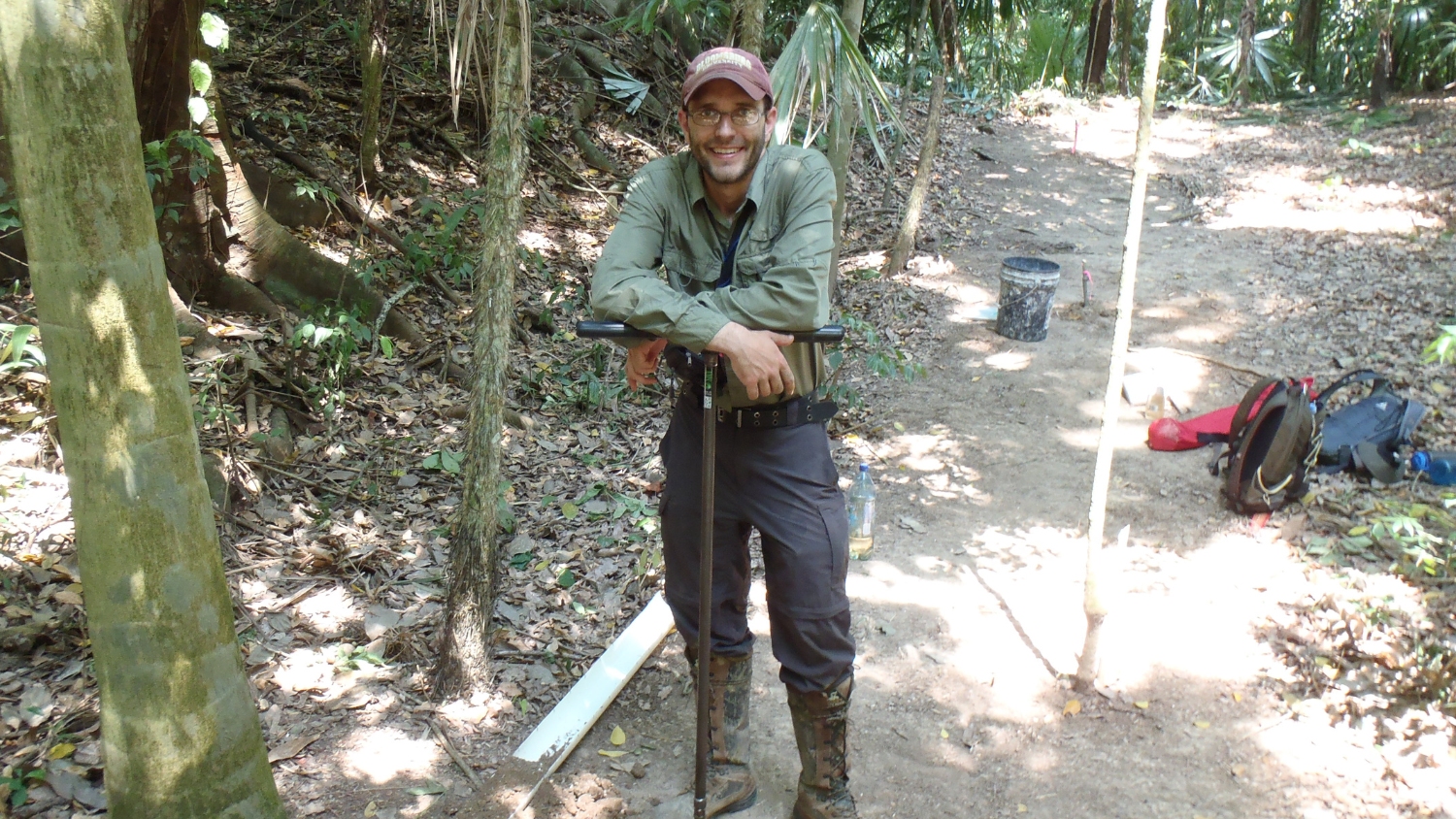 NC State soil scientist Matt Ricker leans on a soil auger at the Maya El-Peru Waka city site.