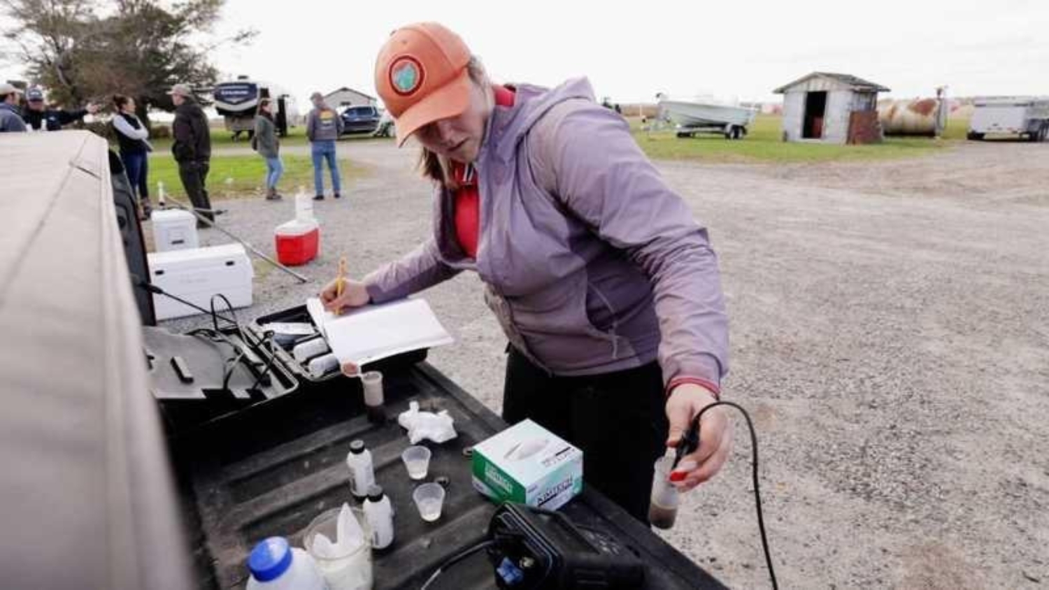 Ph.D. student Julia Fleiner tests soil samples for salinity at a coastal field day.