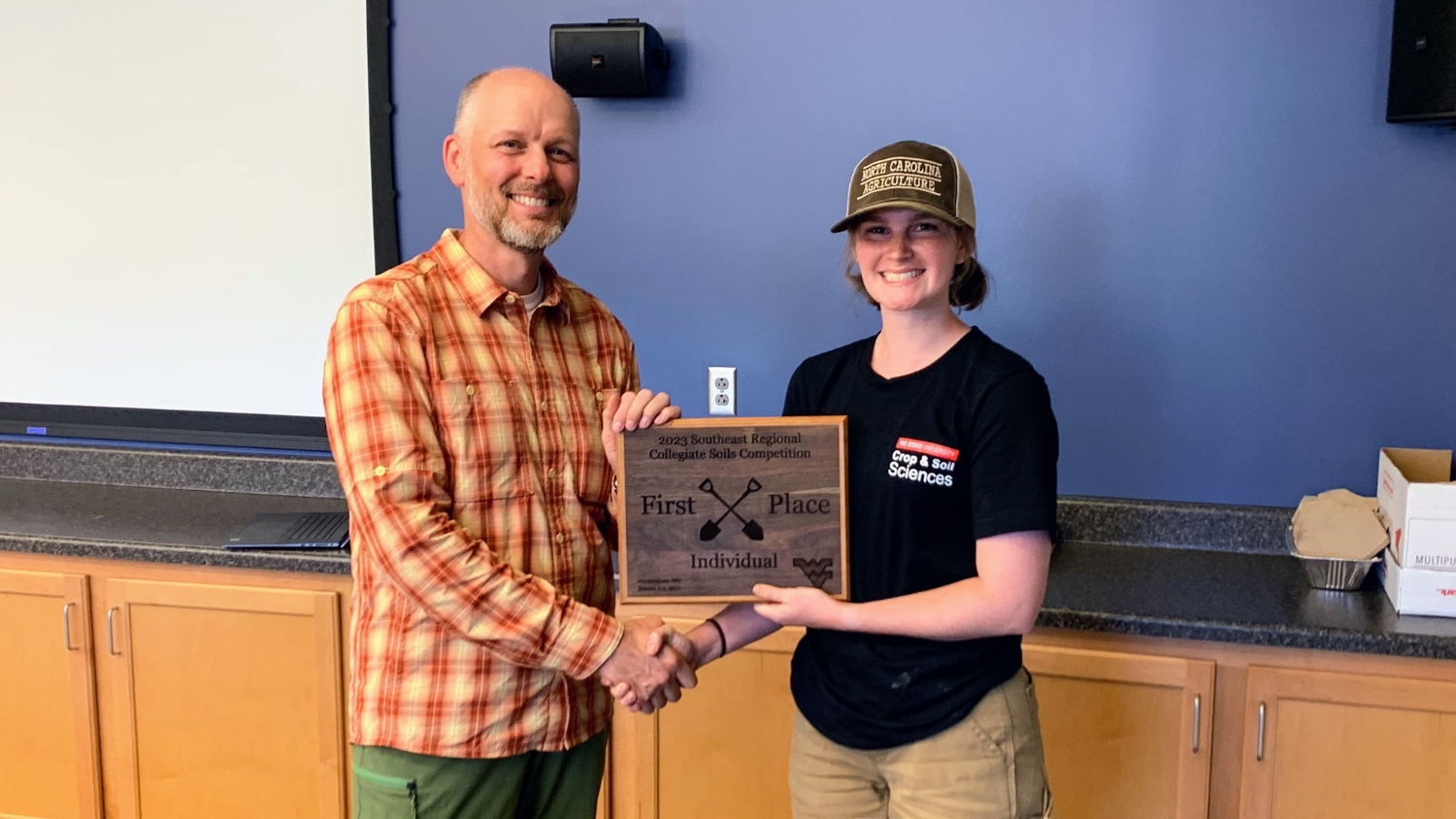 NC State freshman Sarah Bailey accepts a first place award at the 2023 Eastern Collegiate Soil Judging Competition.