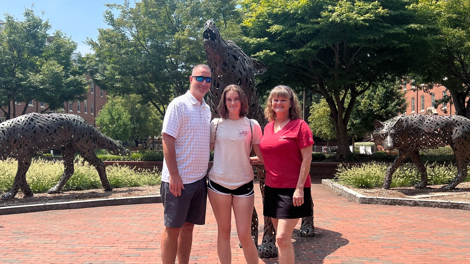 NC State freshman Sarah Bailey poses with her parents on campus.