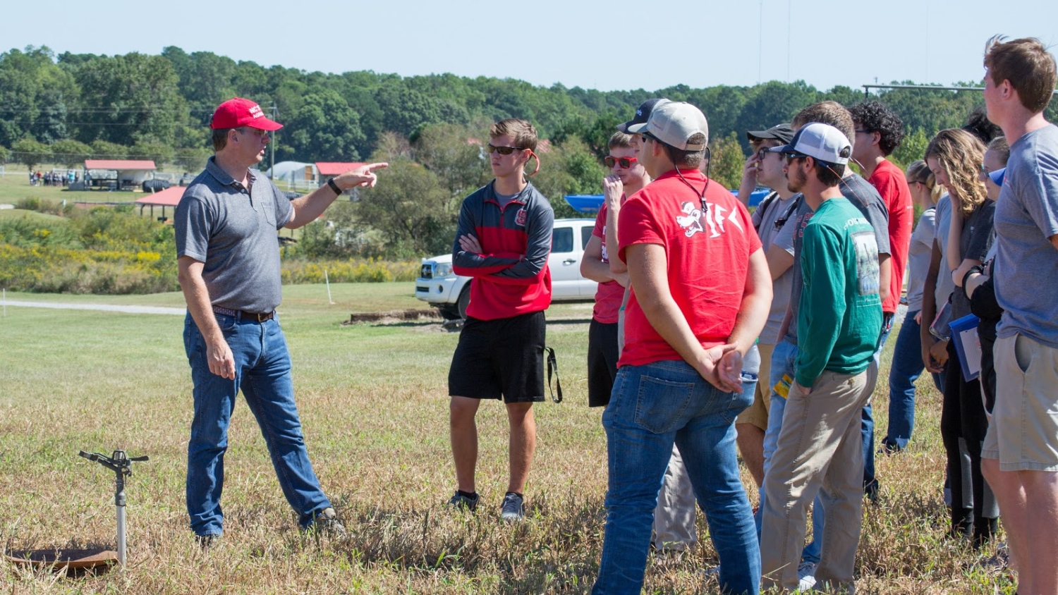 NC State soil science professor David Crouse instructs a group of students in the field