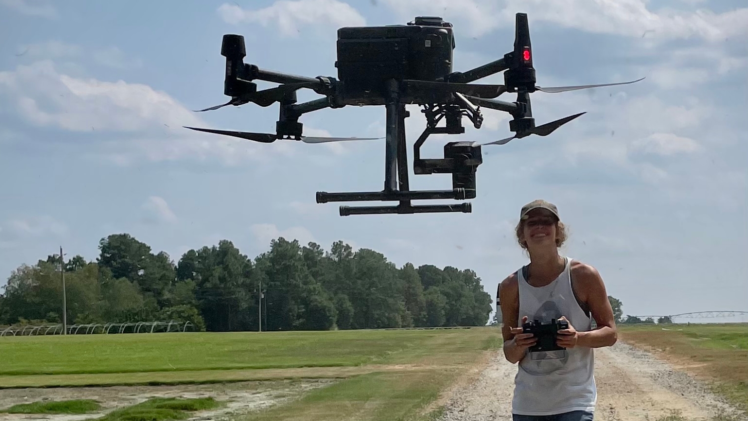 Brynna Bruxellas flies a drone at a turfgrass field
