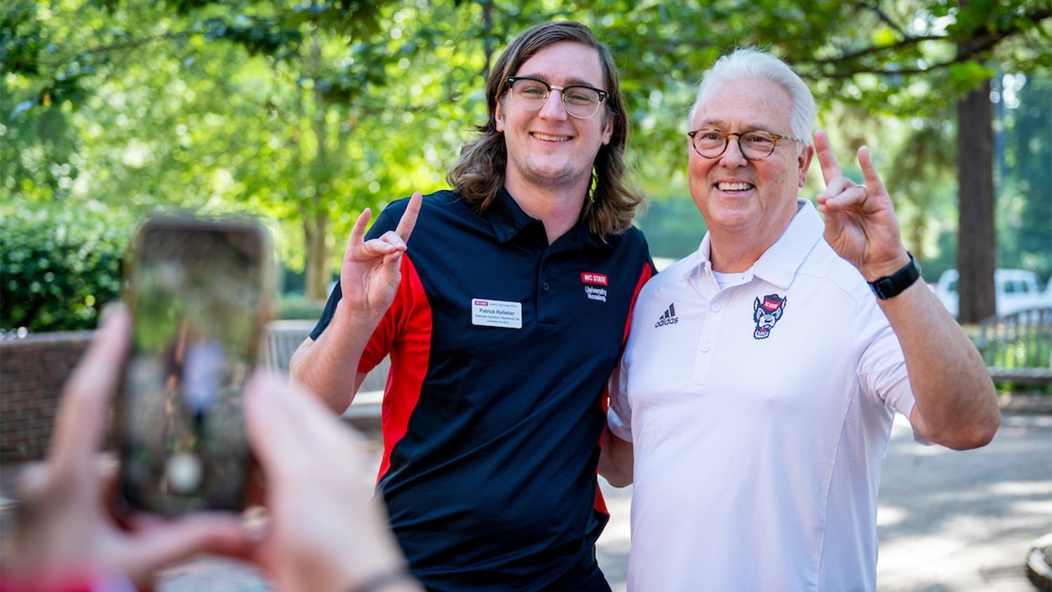 Chancellor Randy Woodson poses with a student on NC State's campus during move-in activities