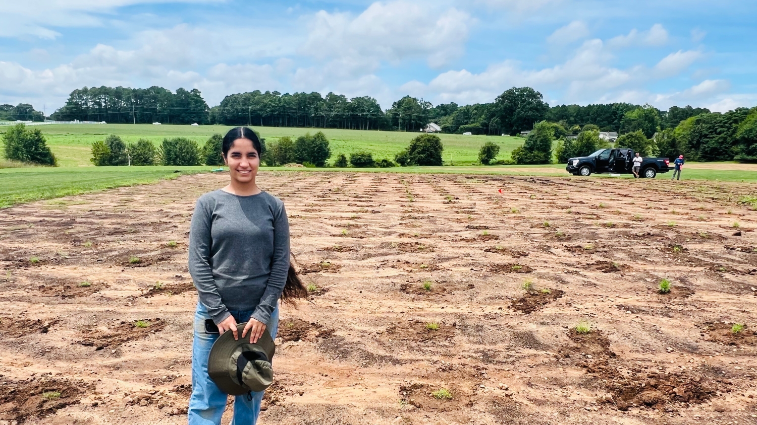 Crop and Soil Sciences graduate student Balihar Kaur poses at an NC State turfgrass research plot