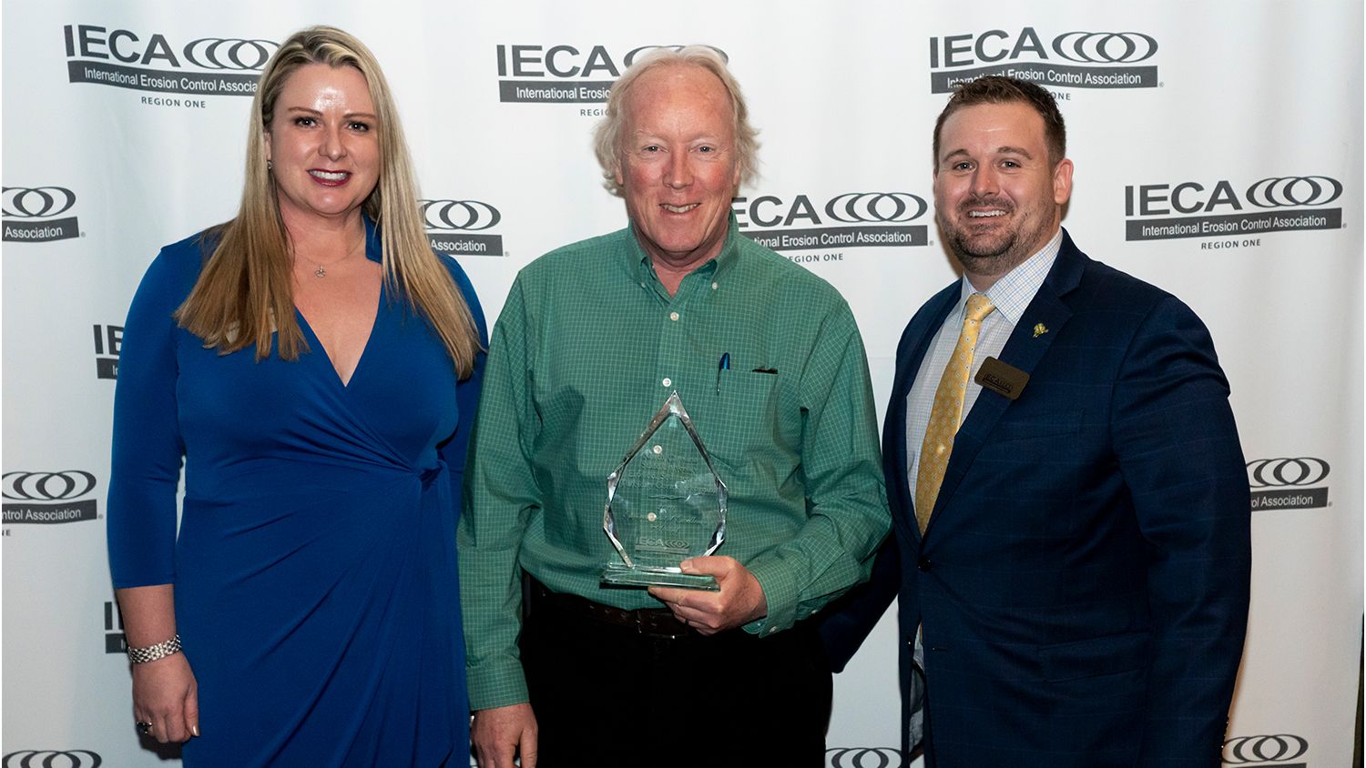 Researchers standing in a group with award trophy