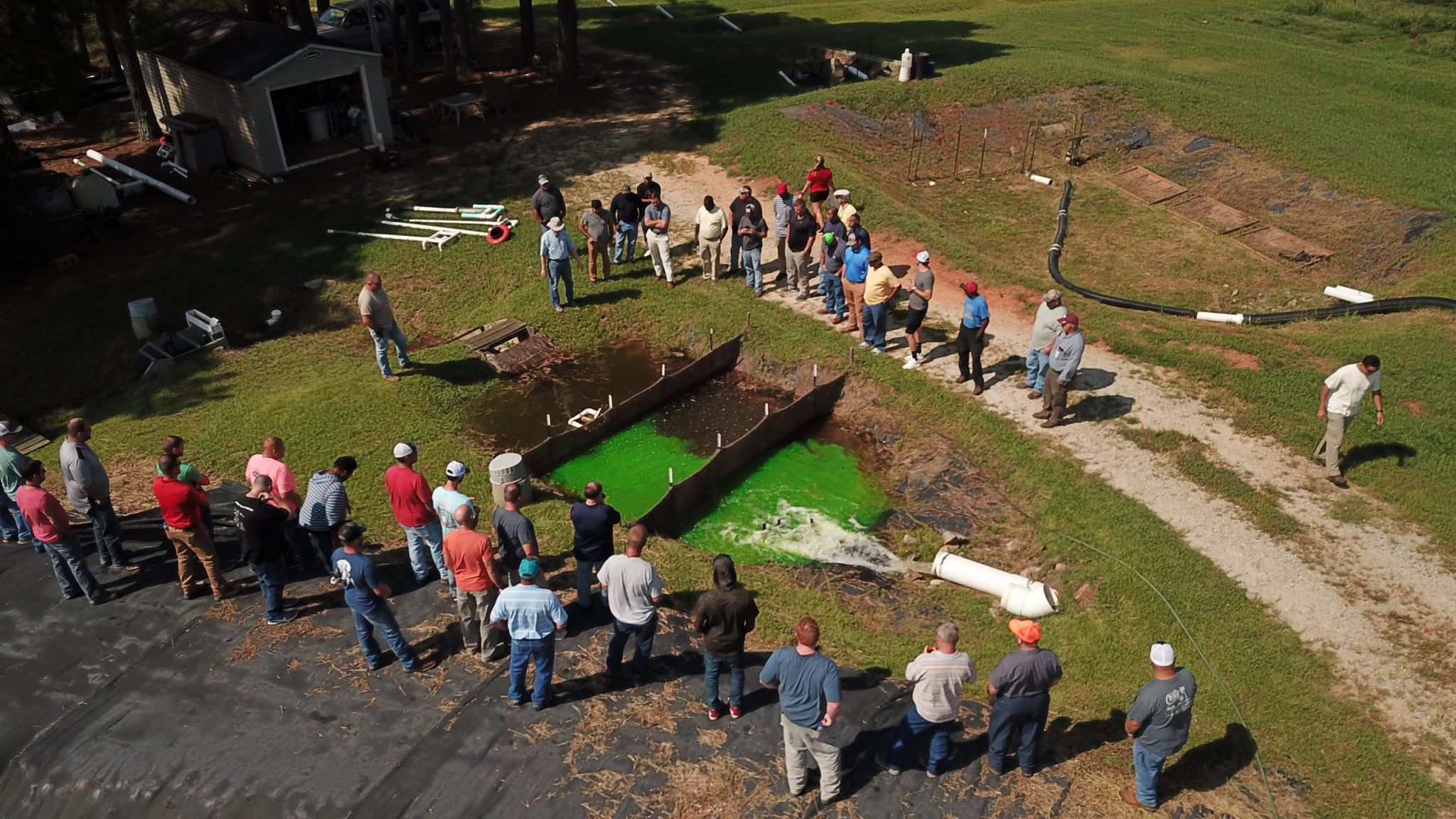 Group of soil students observe a sediment basin