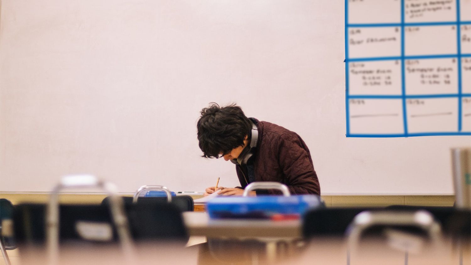 student sitting alone at a desk studying