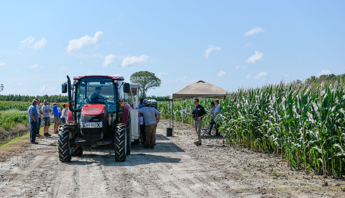 a tractor tours visitors to an Extension field day