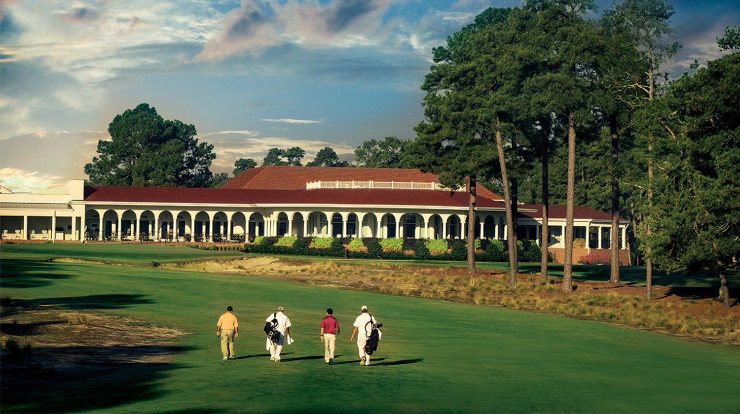 Golfers walk Pinehurst Number 2's 18th fairway